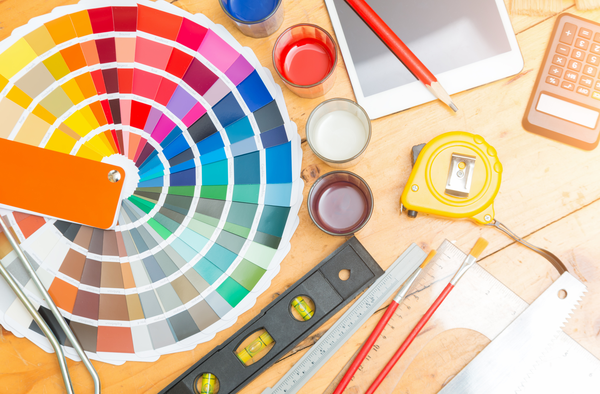 Professional decorator drawing on a house project with work tools